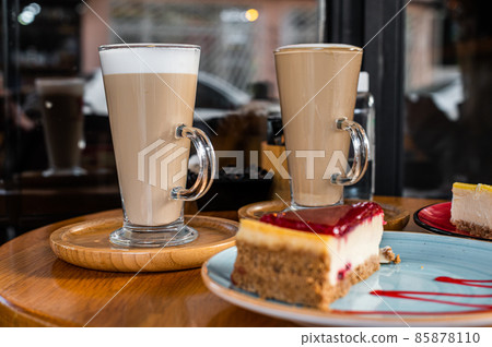 Classic New York Cheesecake And Coffee Latte on a table in cafe. Top view 85878110