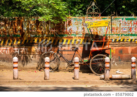 Old time-worn bicycle rickshaw, streets of New Delhi, India 85879802