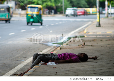 Homeless man sleeping on sidewalk in New Delhi, India Homeless man sleeping on sidewalk in New Delhi, India 85879982