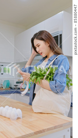woman look at shopping bills woman look at shopping bills 85880447