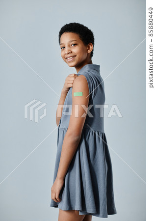 Teenage Girl with Vaccination Plaster Teenage Girl with Vaccination Plaster 85880449