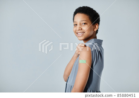 Smiling Girl with Vaccine Plaster Smiling Girl with Vaccine Plaster 85880451