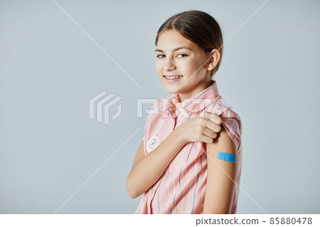 Smiling Girl with Vaccine Patch 85880478