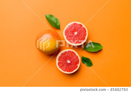 fresh Fruit grapefruit with Juicy grapefruit slices on colored background. Top view. Copy Space. creative summer concept. Half of citrus in minimal flat lay with copy space 85882783