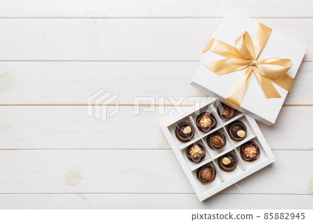 White box with chocolates candies and golden tape. top view with copy space 85882945