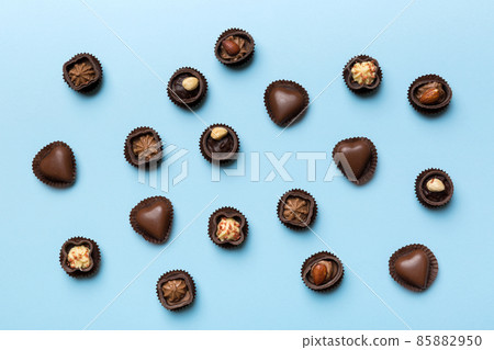 Different kinds of chocolates on colored table close-up. Top View and Flat Lay Different kinds of chocolates on colored table close-up. Top View and Flat Lay 85882950