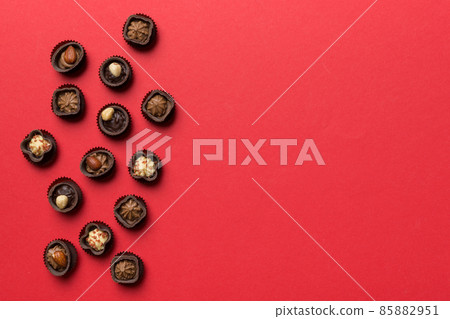 Different kinds of chocolates on colored table close-up. Top View and Flat Lay with copy space Different kinds of chocolates on colored table close-up. Top View and Flat Lay with copy space 85882951