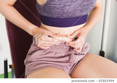 Skin fold test. Young girl pinched herself Skin fold test. Young girl pinched herself 85883494