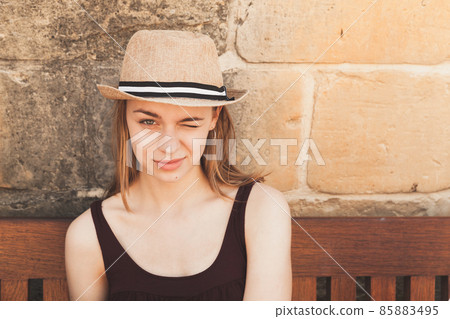Portrait of winking beautiful blond Caucasian girl Portrait of winking beautiful blond Caucasian girl 85883495