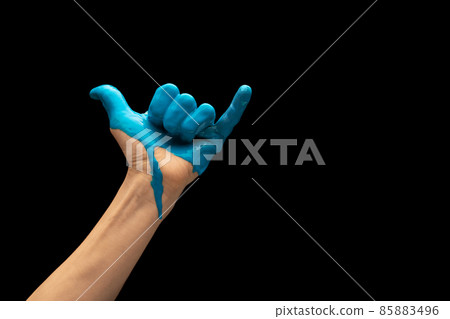 Male hand painted blue gesturing isolated on dark studio background. Concept of human relation, symbolism, culture and history Male hand painted blue gesturing isolated on dark studio background. Concept of human relation, symbolism, culture and history 85883496