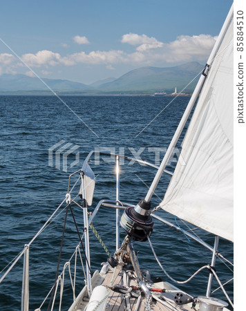 Yacht approaching Lismore lighthouse at entrance to Loch Linnhe, Hebrides 85884510