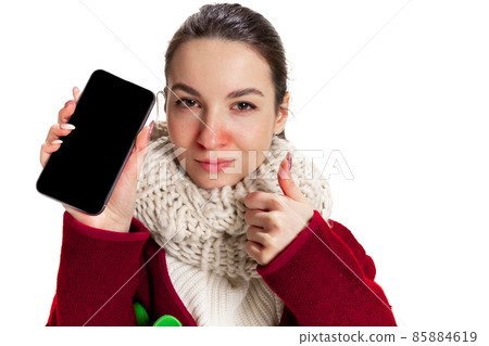 Portrait of young Caucasian girl feeling sick, has running nose isolated over white studio background. Flu, cold, allergy Portrait of young Caucasian girl feeling sick, has running nose isolated over white studio background. Flu, cold, allergy 85884619