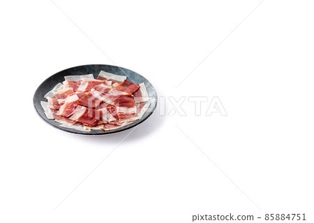 Spanish serrano ham slice on black plate Spanish serrano ham slice on black plate 85884751