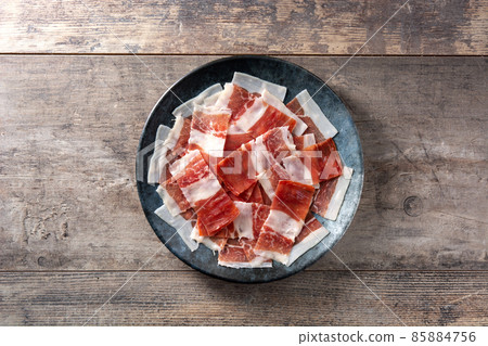 Spanish serrano ham slices on black plate Spanish serrano ham slices on black plate 85884756