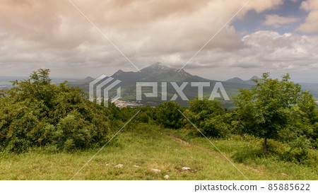 mountain view from a green clearing mountain view from a green clearing 85885622