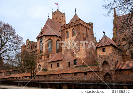 The Castle of the Teutonic Order in Malbork in the Pomerania region, Poland. This is the largest castle in the world measured by land area and a UNESCO World Heritage Site The Castle of the Teutonic Order in Malbork in the Pomerania region, Poland. This is the largest castle in the world measured by land area and a UNESCO World Heritage Site 85886292