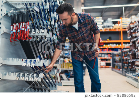 a buyer in a construction hypermarket chooses a nail puller a buyer in a construction hypermarket chooses a nail puller 85886592