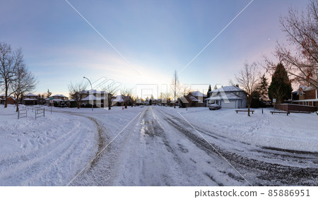 Residential Neighborhood in the Suburbs with White Snow covered road Residential Neighborhood in the Suburbs with White Snow covered road 85886951