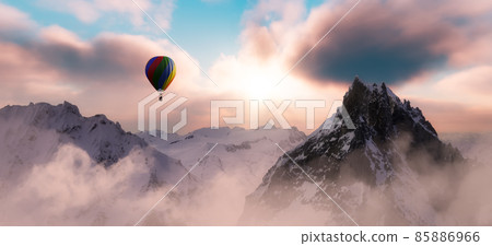 Dramatic Mountain Landscape covered in clouds and Hot Air Balloon Flying. 85886966