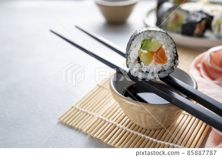 Sushi rolls close up with salmon, avocado and cucumber. 85887787