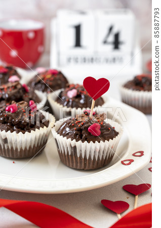 Valentine's day, chocolate homemade muffins, cupcakes with heart sprinkles. Valentine's day, chocolate homemade muffins, cupcakes with heart sprinkles. 85887793