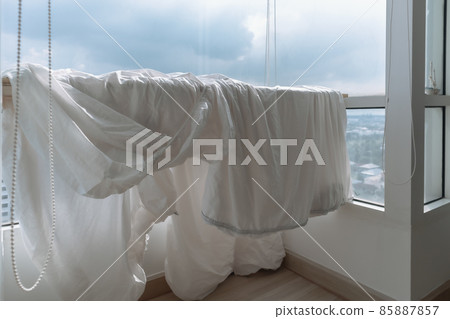 Bed sheets and duvet clothes hanging on the balcony to dry in apartment. Bed sheets and duvet clothes hanging on the balcony to dry in apartment. 85887857