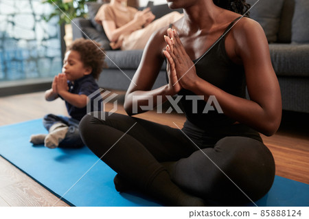 Mother and Son Meditating Together 85888124