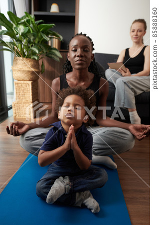Boy Practicing Yoga with His Mother 85888160