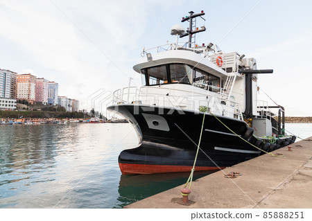 Industrial fishing boat is moored in small fishing harbor 85888251