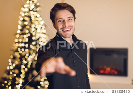 Excited young man reaching hand to camera 85888420