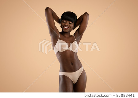 Sensual attractive black model posing in underwear, isolated Sensual attractive black model posing in underwear, isolated 85888441