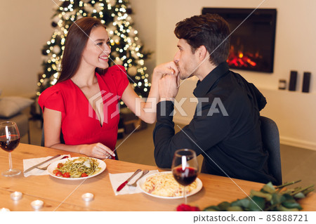 Romantic young man kissing his beloved woman's hands 85888721