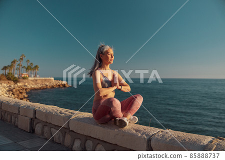 Strong active female training by the waterfront 85888737