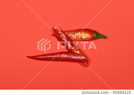 Red chili pepper isolated on red background. High resolution photo 85889128