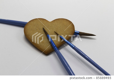heart shaped cookies on white background with blue paintbrushes, food decoration, Pastry art, cookies decoration, horizontal, copy space 85889493