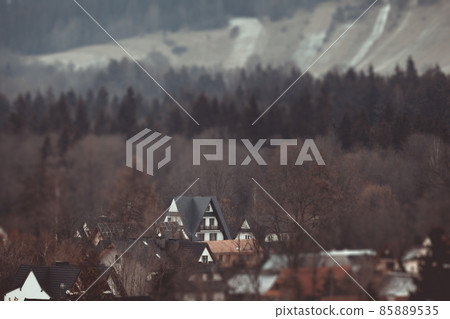 Dark landscape tilt-shift houses background. Tilt-shift miniature effect of winter scenery. 85889535