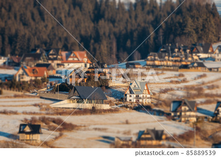 Dark landscape tilt-shift houses background. Tilt-shift miniature effect of winter scenery. 85889539