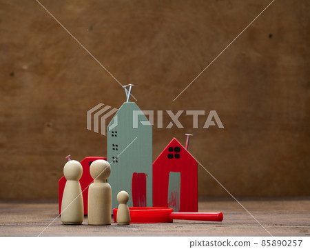wooden family figurines, model house on a brown background. Real estate purchase, rental concept. Moving to new apartments wooden family figurines, model house on a brown background. Real estate purchase, rental concept. Moving to new apartments 85890257