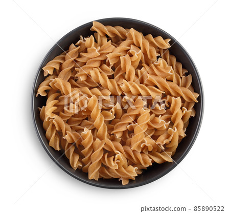 Wolegrain fusilli pasta from durum wheat in ceramic bowl isolated on white background with clipping path and full depth of field. Top view. Flat lay. Wolegrain fusilli pasta from durum wheat in ceramic bowl isolated on white background with clipping path and full depth of field. Top view. Flat lay. 85890522