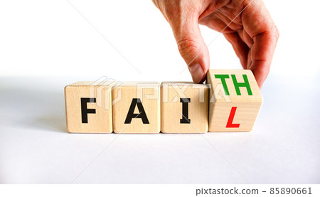 Faith instead fail symbol. Businessman turns a wooden cube and changes the word fail to faith. Beautiful white table, white background. Business and faith instead fail concept. Copy space. 85890661