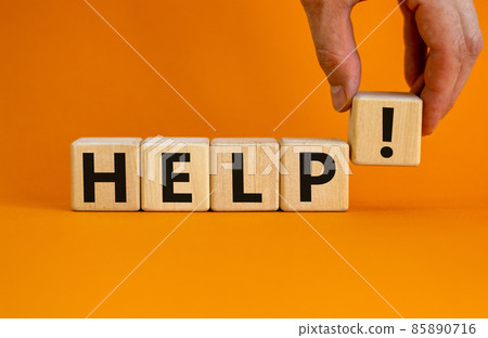 Support and help symbol. Wooden cubes with the word 'help'. Businessman hand. Business, psychology, support and help concept. Beautiful orange background, copy space. 85890716