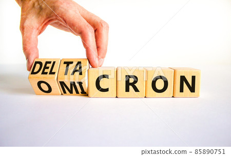 Covid-19 omicron or deltacron symbol. Doctor turns cubes and changes the word omicron to deltacron. Beautiful white background. Medical, covid-19 corona omicron or deltacron concept. Copy space. 85890751