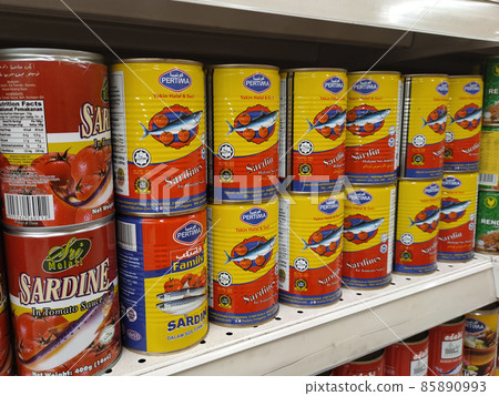 PENANG, MALAYSIA -DECEMBER 09, 2021: Selective focused on sardine fish can. The fish has been processed, cook and packed in the can. Displayed on the rack for sale and tag with the price tag 85890993