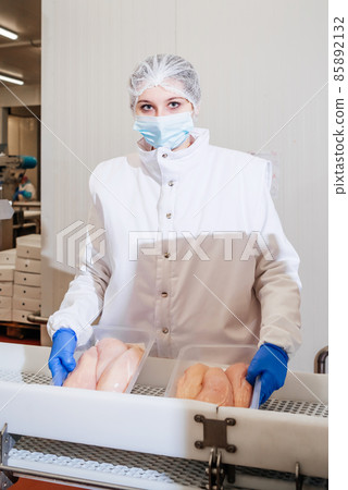 Automated production line with packaging and cutting of meat in modern food factory.Meat processing equipment. Food products meat chicken fillet production line in plastic packaging on the conveyor. Automated production line with packaging and cutting of meat in modern food factory.Meat processing equipment. Food products meat chicken fillet production line in plastic packaging on the conveyor. 85892132