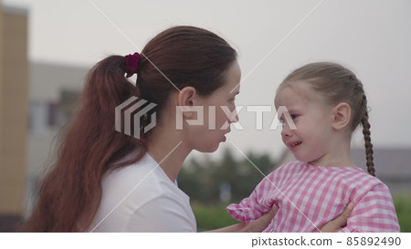 a small child sheds tears on the shoulder of an embracing mother, crying of an upset kid, childhood emotions of a capricious baby, a problem for an unhappy girl, experiencing pain of strong feelings a small child sheds tears on the shoulder of an embracing mother, crying of an upset kid, childhood emotions of a capricious baby, a problem for an unhappy girl, experiencing pain of strong feelings 85892490