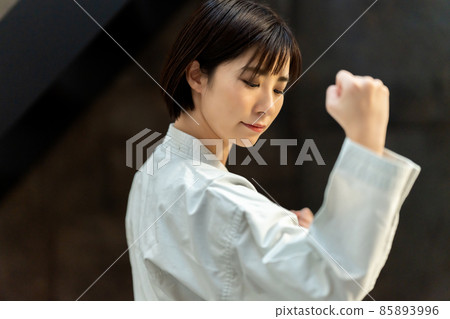 A woman preparing for karate 85893996