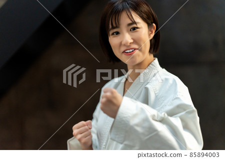 A woman preparing for karate 85894003