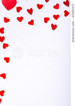 Overhead view of red heart shape cutting decoration scattered with copy space on white background Overhead view of red heart shape cutting decoration scattered with copy space on white background 85895837
