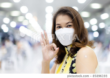 Asian woman wearing protective hygiene face mask happy pose to camera after finished getting vaccine for coronavirus or covid-19 85896193