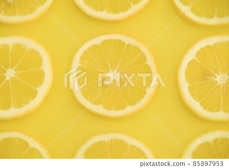 Slice of lemon on a yellow background 85897953